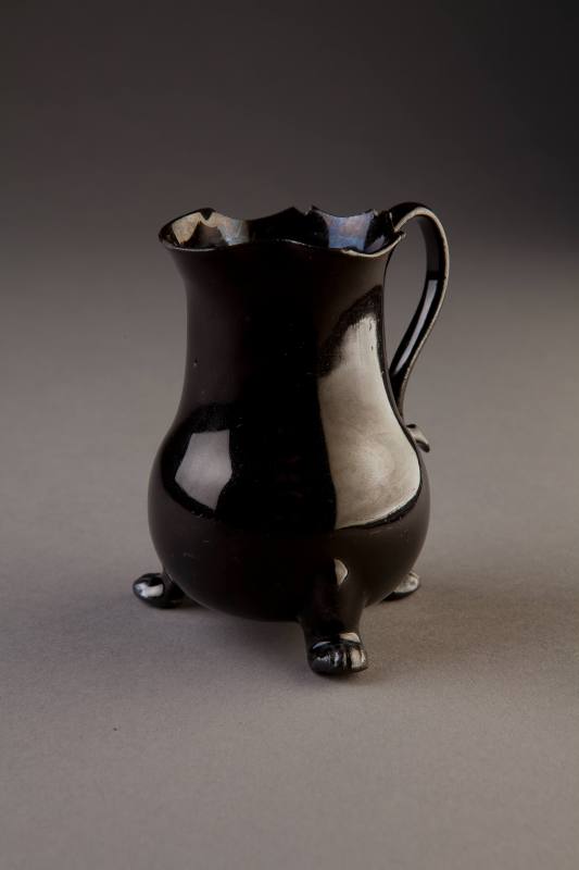 Staffordshire, Black-Glazed Brown Stoneware Milk Jug with Three Paw Feet, ca. 1765. Brown stone ...